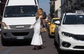 MILAN, ITALY -JUNE 18, 2018: Fashionable woman waits a taxi in the street after AALTO fashion show