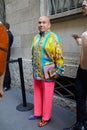 Man with pink trousers and yellow and blue silk short before Versace fashion show, Milan Fashion