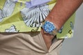 Man with Rolex Subariner watch with blue dial, gold and steel before MSGM fashion show, Milan