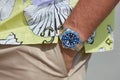 Man with Rolex Submariner watch with blue dial, gold and steel before MSGM fashion show, Milan