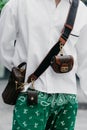 Milan, Italy - June, 19, 2022: man wears brown mini paisley shoulder bag from Etro, street style.