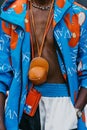 Milan, Italy - June, 19, 2022: man wears JW Anderson blue hooded logo jacket and cap medium crossbody bag, street style.