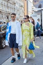 Man with white and blue shirt and woman with yellow dress before Palm Angels fashion show, Milan