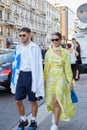 Man with white and blue shirt and woman with yellow dress before Palm Angels fashion show, Milan