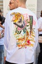 Man with white shirt with tiger head and writings design before Etro fashion show, Milan Fashion