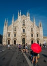 Milan, Italy - June 23rd, 2017: Asian tourists pose for a picture in front of the Milan`s iconic Duomo cathedral. Italy remains p Royalty Free Stock Photo