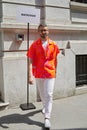 Simone Marchetti with orange shirt and white trousers before Marni fashion show, Milan Fashion Week