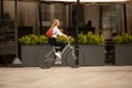 Female cyclist riding her bicycle through Piazza del Duomo