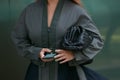 Woman with gray dress and green nail polish before Emporio Armani fashion show, Milan Fashion Week