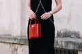 Milan, Italy - June, 19, 2022: woman wearing red leather Prada shoulder bag. Fashion blogger outfit detail Royalty Free Stock Photo