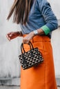 Milan, Italy - June, 19, 2022: woman wears and land Symbole bag from Prada.