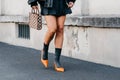 Milan, Italy - June, 19, 2022: woman wears slingback heels from Prada and Symbole mini bag.