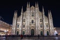Milan, Italy low angle wide shot of illuminated gothic style Roman Catholic Duomo Cathedral facade at the homonym main square