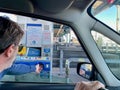 Milan, Italy, 19.04.2022. Man paying with card at toll station on Italian highway. Royalty Free Stock Photo