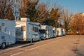 Milan, Italy 28.11.2023 Many white modern campervan recreational motor home vehicles parked in row at camper park site Royalty Free Stock Photo