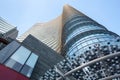 Milan, Italy, March 2020. Low angle view of a high-rise building with beautiful entrance decor. Glass roof with geometric shapes/