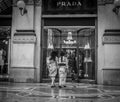 Milan, Italy - March 23, 2016: Two Japanese female enter in Prada luxury clothes shop in Galleria Vittorio Emanuele II in Royalty Free Stock Photo