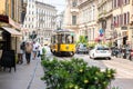 Milan. Old Yellow MIlan Tram. Street Panorama with Pedestrians and Cars on a Sunny Day