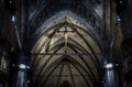 Statue of crucified Jesus Christ inside Milan Cathedral. Holy cross in interior of dark Catholic church, view of crucifix in altar Royalty Free Stock Photo