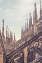 View of Milan Cathedral roof. People visit beautiful terrace. Milan Cathedral or Duomo di Milano is top tourist attraction of