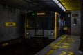 Milan, Italy 03.2024: A metro train arrives at Duomo station in the center of Milan. Yellow metro line Royalty Free Stock Photo