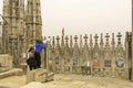 Milan, Italy, 24 nov 2017. On the roof Of Milan Cathedral mother and child look through a telescope