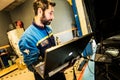 Mechanic perform chip tuning on tuned car in a garage workshop