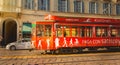 old red tram from the company Azienda Trasporti Milanesi circulating in Milan