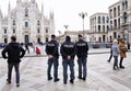 Three policemen on their backs in the Piazza del Duomo in Milan.