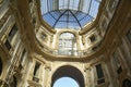 Milan, Italy, October 2021: Galleria Vittorio Emanuele II, an old shopping gallery, upwards view from inside the arcade. Royalty Free Stock Photo