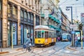 Man on a bicycle passing in front of the old tram of Milan Royalty Free Stock Photo