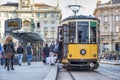 Passengers entering the typical old tram of Milan.