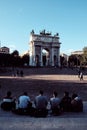 MILAN, ITALY - OCTOBER 2022: A view of Piazza Sempione with Arch of Peace, a neoclassical arch and group of boys