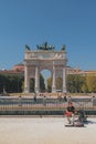 Milan, Italy- Sep 28, 2018: Street musician and triumphal arch Arco della Pace Royalty Free Stock Photo