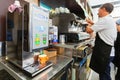 MILAN, ITALY - September 07, 2016: Barista is preparing coffee in a small cozy cafe in the morning in Milan. Real live coffee maki