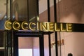 Coccinelle logo displayed on a facade of a store in Milan
