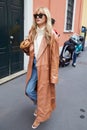 Eleonora Carisi with beige, long leather jacket before Boss fashion show, Milan Fashion Week