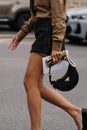 Milan, Italy - September 21, 2023: fashioner wearing Prada Arque black shoulder bag. Fashion blogger outfit details