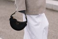 Milan, Italy - September 21, 2023: fashioner wearing Prada Arque black shoulder bag. Fashion blogger outfit details