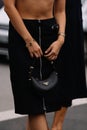 Milan, Italy - September 21, 2023: fashioner wearing Prada Arque black shoulder bag. Fashion blogger outfit details