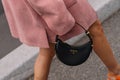 Milan, Italy - September 21, 2023: fashioner wearing Prada Arque black shoulder bag. Fashion blogger outfit details