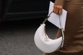 Milan, Italy - September 21, 2023: fashioner wearing Prada Arque white shoulder bag. Fashion blogger outfit details Royalty Free Stock Photo