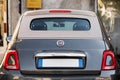 Milan, Italy - September 1, 2022: Fiat 500 classic retro car parked at city street road. Iconic vintage car at city Royalty Free Stock Photo