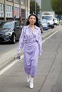 Jessica Wang with lilac skirt and striped shirt walking before MSGM fashion show, Milan Fashion