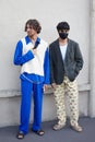 Man with blue trousers and shirt and gray jacket before Prada fashion show, Milan Fashion Week Royalty Free Stock Photo