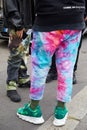 Man with green Versace sneakers and blue and pink trousers before Fila fashion show, Milan