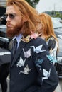 Man with paper origami swans on jacket before Gucci fashion show, Milan Fashion Week street