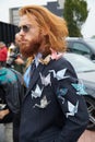 Man with paper origami swans on jacket before Gucci fashion show, Milan Fashion Week street