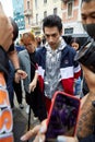 Man with silver, blue, white and red Fila jacket before Fila fashion show, Milan Fashion Week