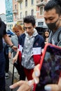 Man with silver, blue, white and red Fila jacket before Fila fashion show, Milan Fashion Week